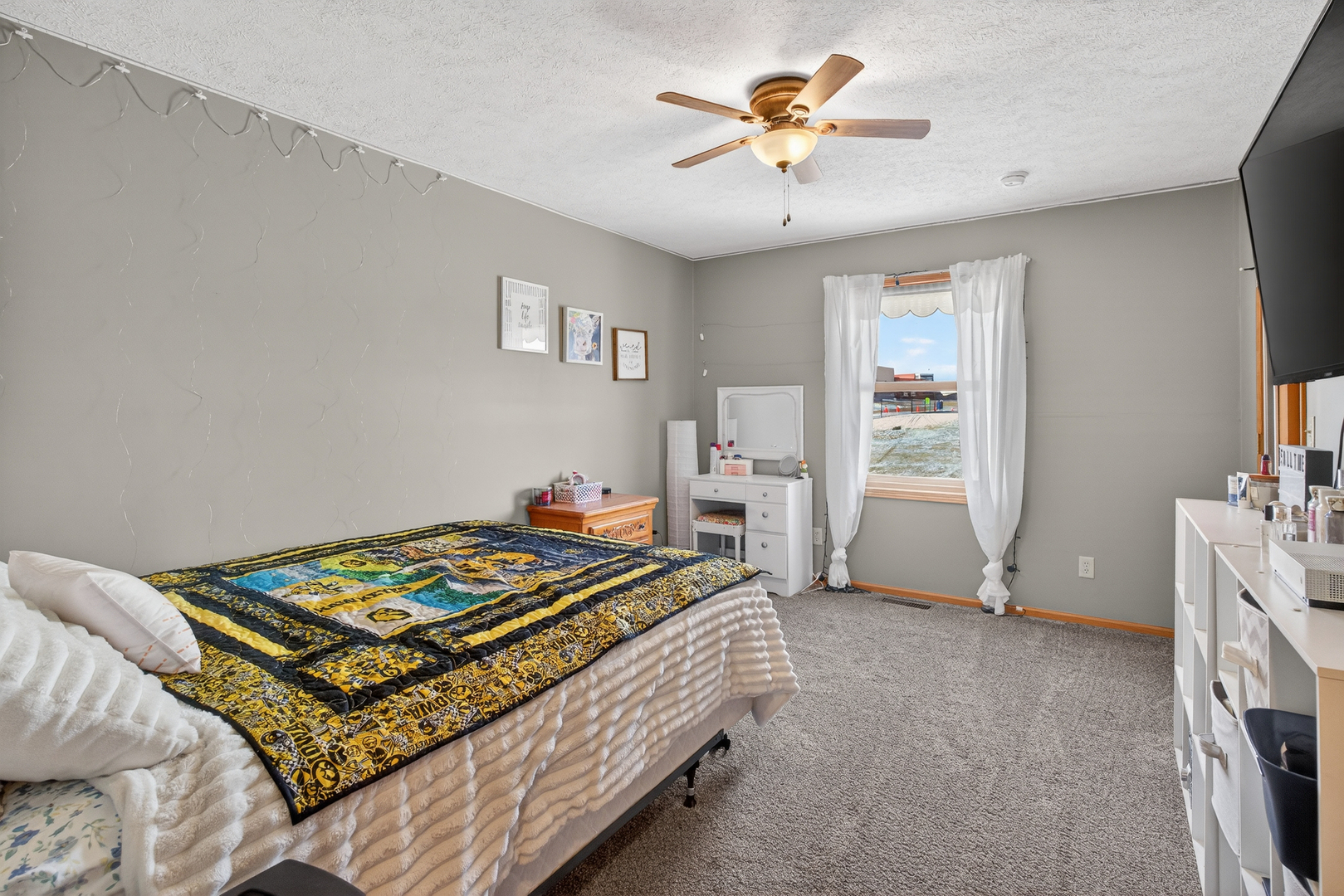 2712 North 13th Street Clinton, IA 52732 - Photo 30 of 47 a bedroom with a bed and a chandelier