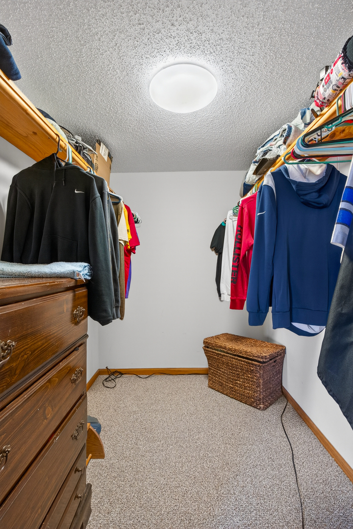 2712 North 13th Street Clinton, IA 52732 - Photo 35 of 47 a view of walk in closet with clothes and shoes