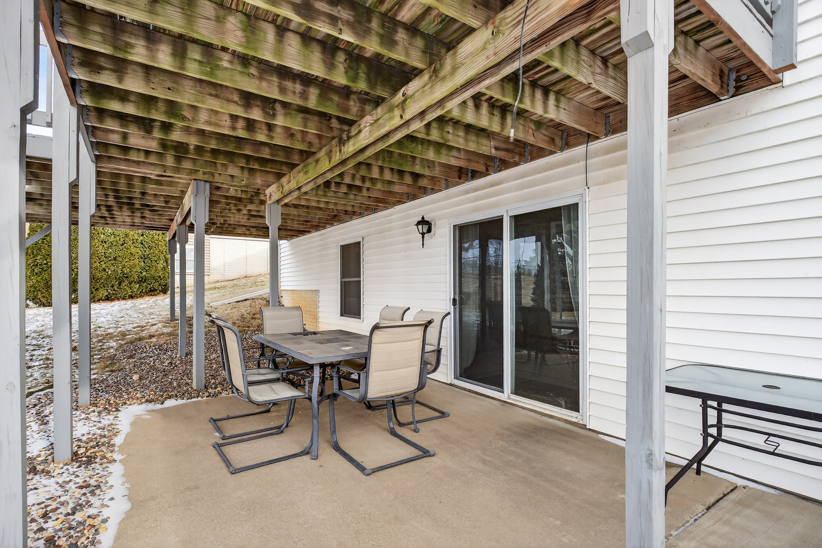 2712 North 13th Street Clinton, IA 52732 - Photo 47 of 47 a view of a patio with table and chairs with wooden floor and fence