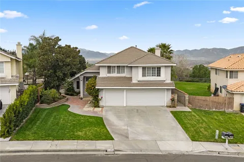 a view of a house with a yard and sitting area