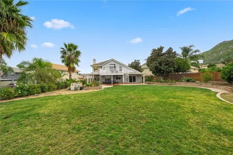 a backyard of a house with a table and chairs