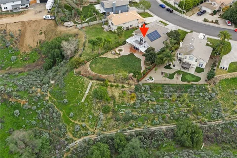 a dining room with wooden floor a chandelier a glass table and chairs