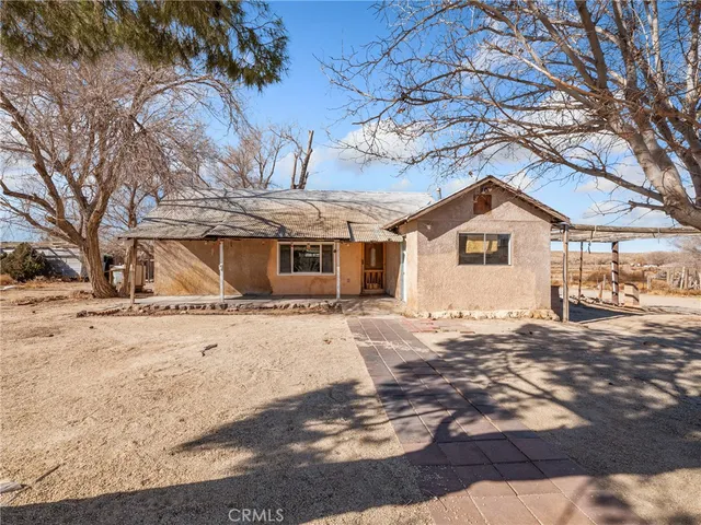 a front view of a house with a yard covered in snow