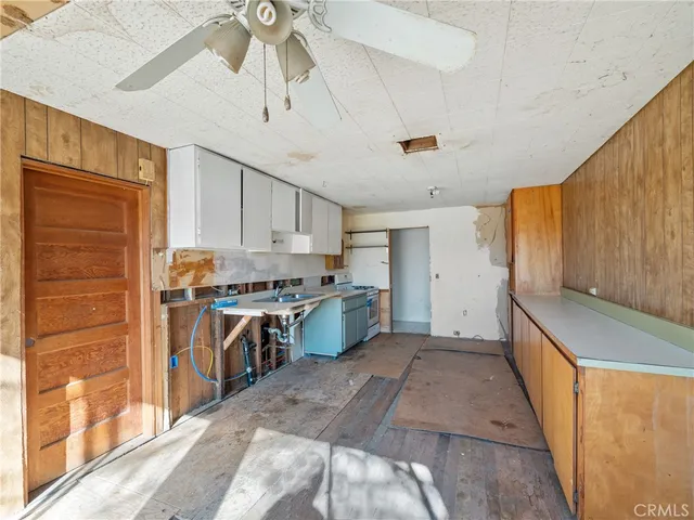 a kitchen with a refrigerator a stove top oven a sink and dishwasher