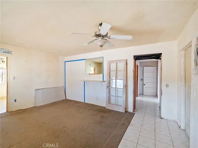 wooden floor in an empty room with a bathroom