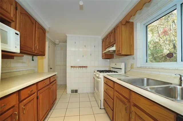 a kitchen with a sink stove and cabinets