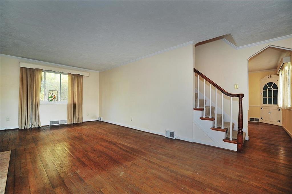 2381 Collins Road Pittsburgh, PA 15235 - Photo 6 of 20 a view of an empty room with wooden floor and stairs