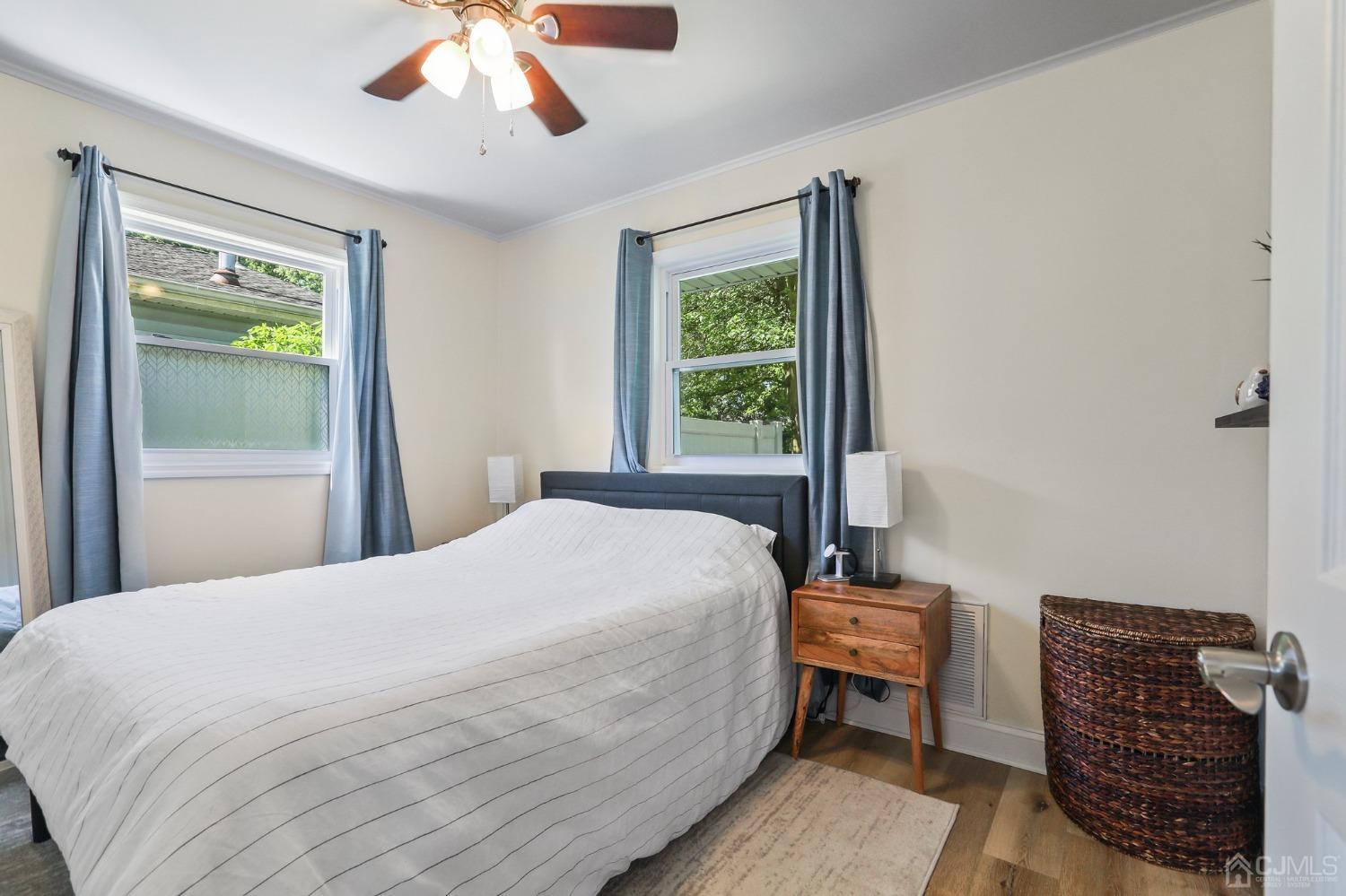 794 Maplecrest Road Toms River, NJ 08753 - Photo 11 of 20 a bedroom with a bed a window and a chandelier