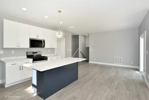 a kitchen with a sink a microwave and cabinets