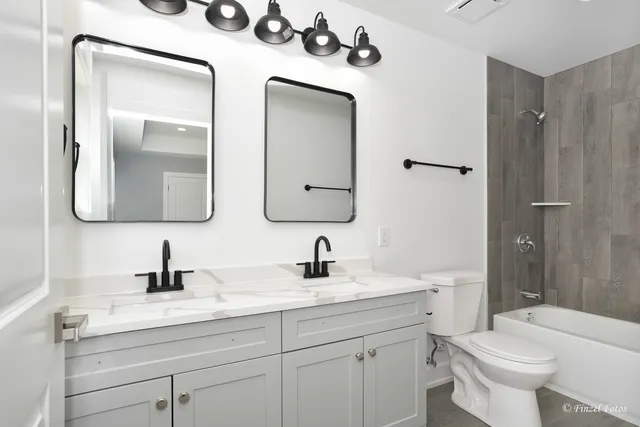 a bathroom with a sink a toilet and a mirror