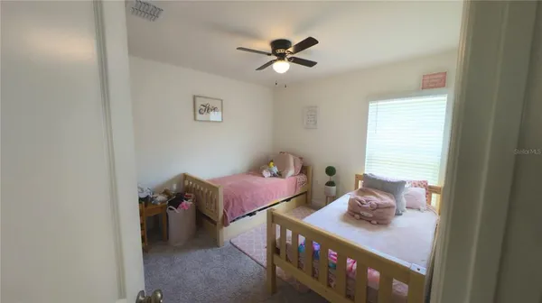 a bedroom with furniture and a window