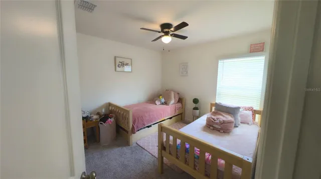 a bedroom with furniture and a window