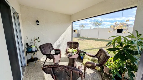 a view of a living room with furniture and floor to ceiling window