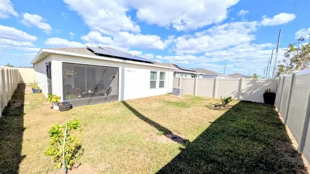 a swimming pool with yard in front of it