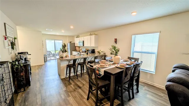 a view of a dining room with furniture and wooden floor