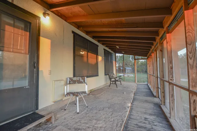 a view of a kitchen with a sink and a refrigerator