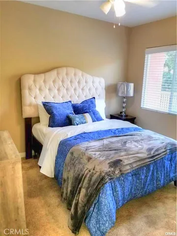 a bedroom with a bed and window