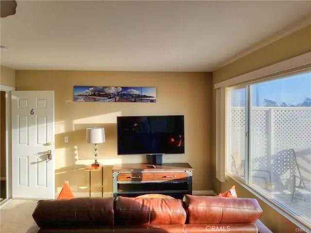 a view of a small space with wooden floor and a window