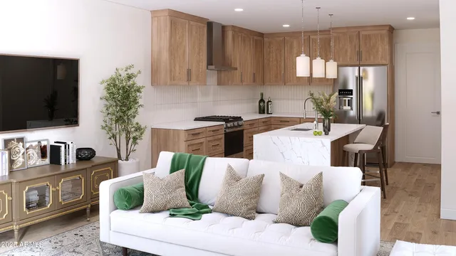 a living room with furniture a flat screen tv and kitchen view