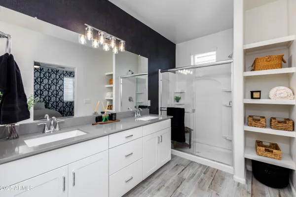 a bathroom with a double vanity sink and a mirror