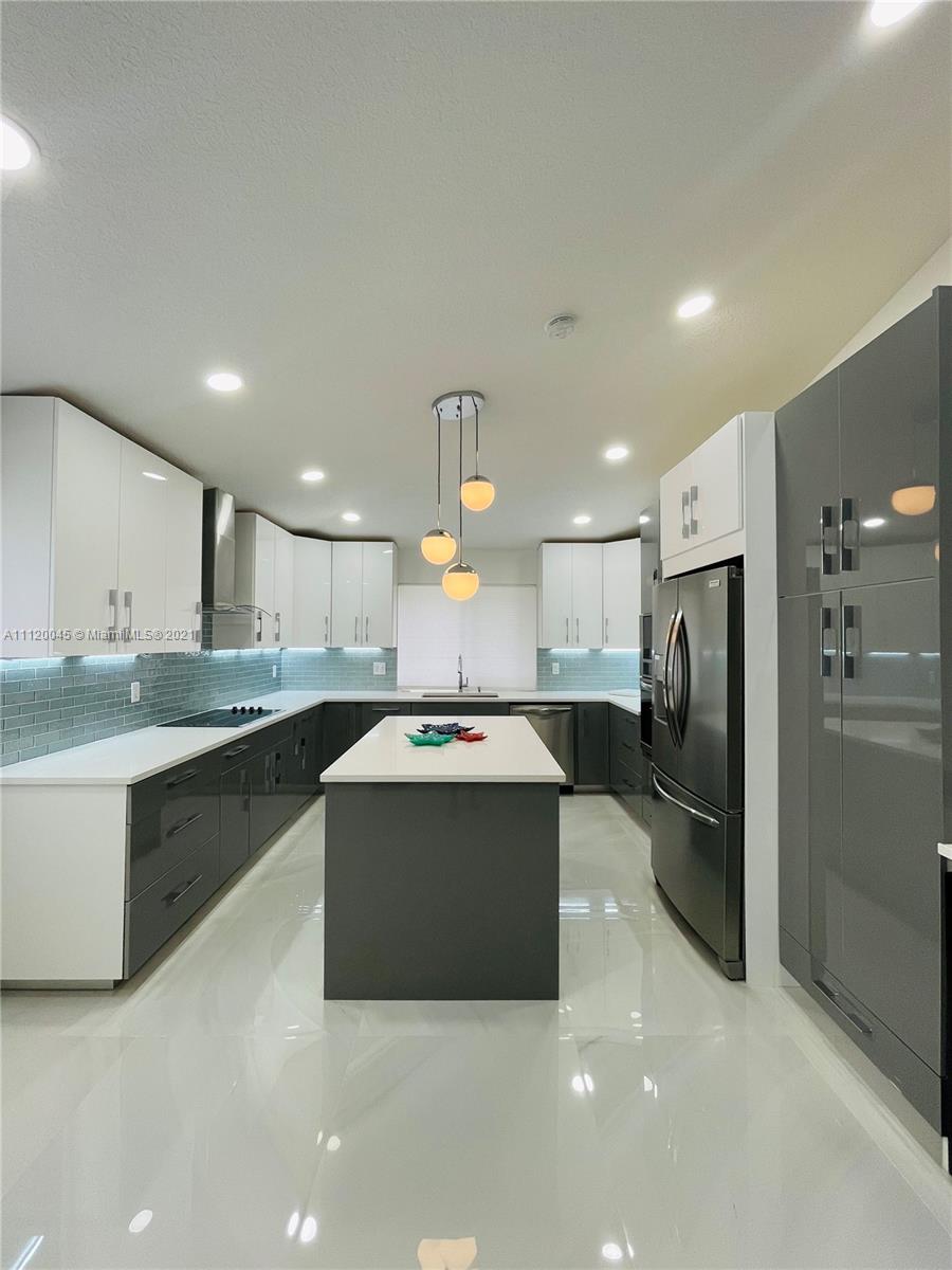 6726 Via Regina Boca Raton, FL 33433 - Photo 1 of 35 a kitchen with stainless steel appliances granite countertop a refrigerator and a sink