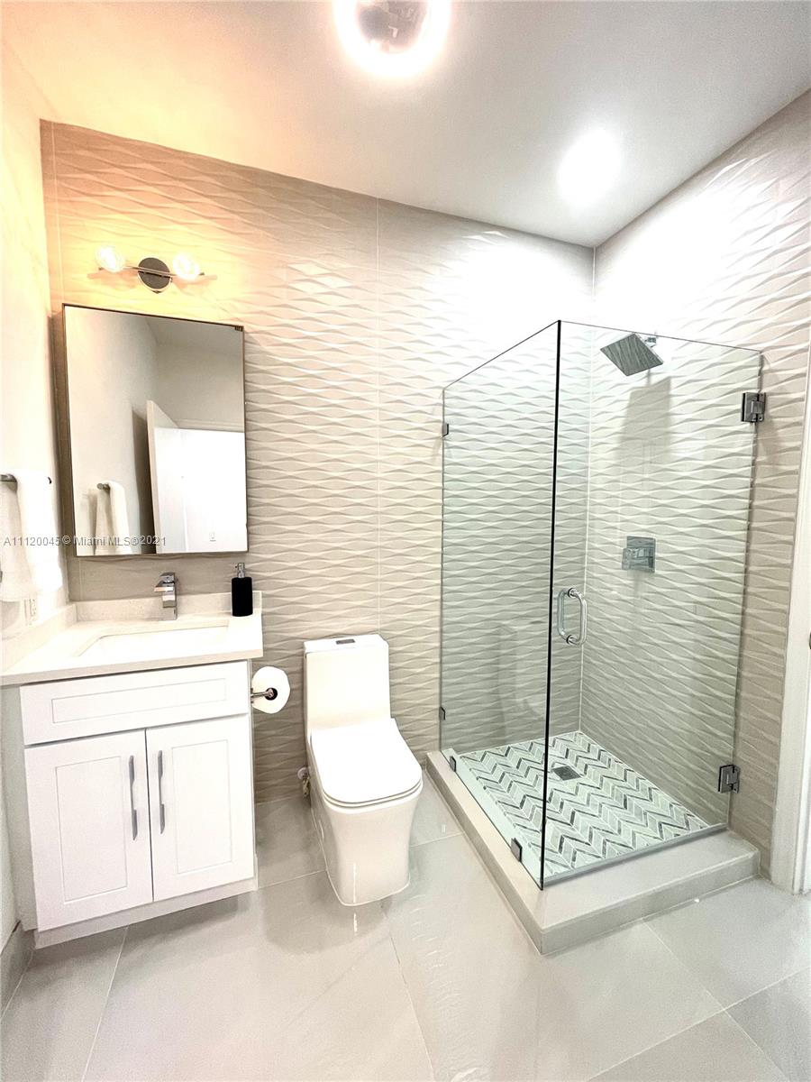 6726 Via Regina Boca Raton, FL 33433 - Photo 13 of 35 a bathroom with a toilet a sink and a mirror
