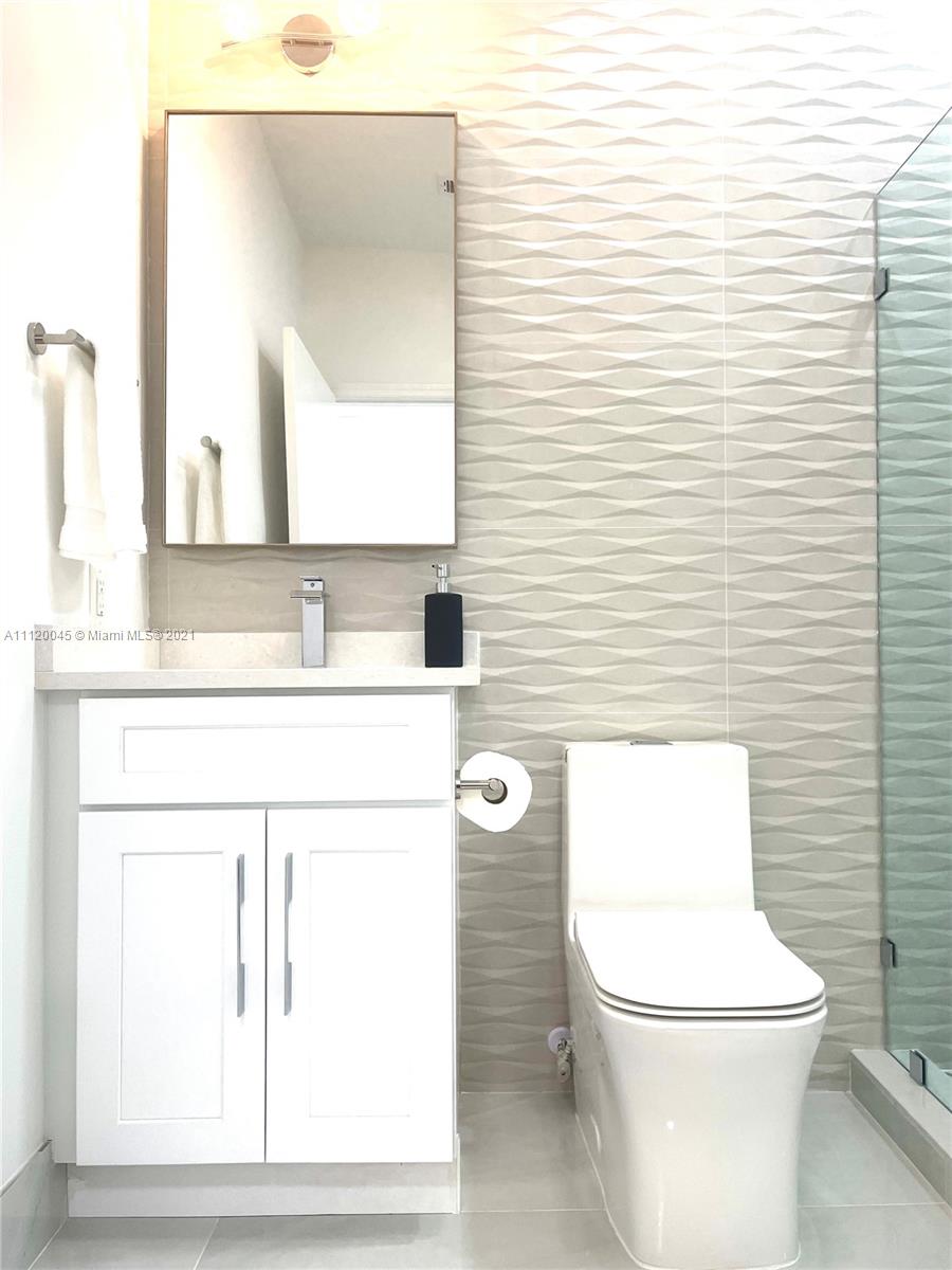 6726 Via Regina Boca Raton, FL 33433 - Photo 14 of 35 a white toilet sitting next to a bathroom sink