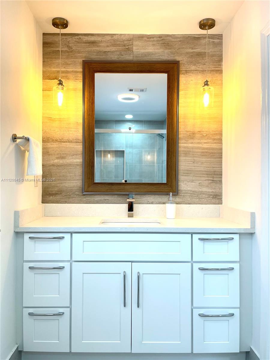 6726 Via Regina Boca Raton, FL 33433 - Photo 18 of 35 a bathroom with a sink a vanity and a mirror