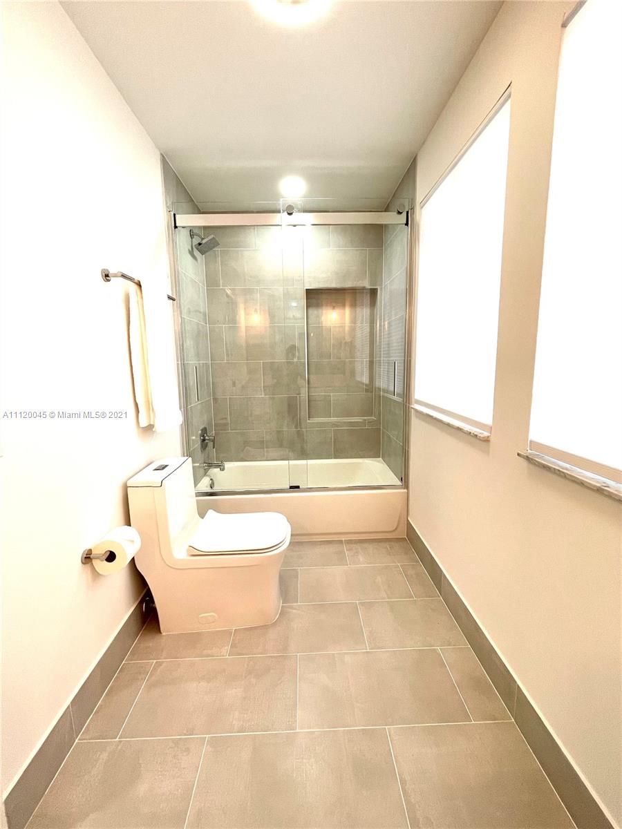 6726 Via Regina Boca Raton, FL 33433 - Photo 19 of 35 a bathroom with a bathtub and a shower