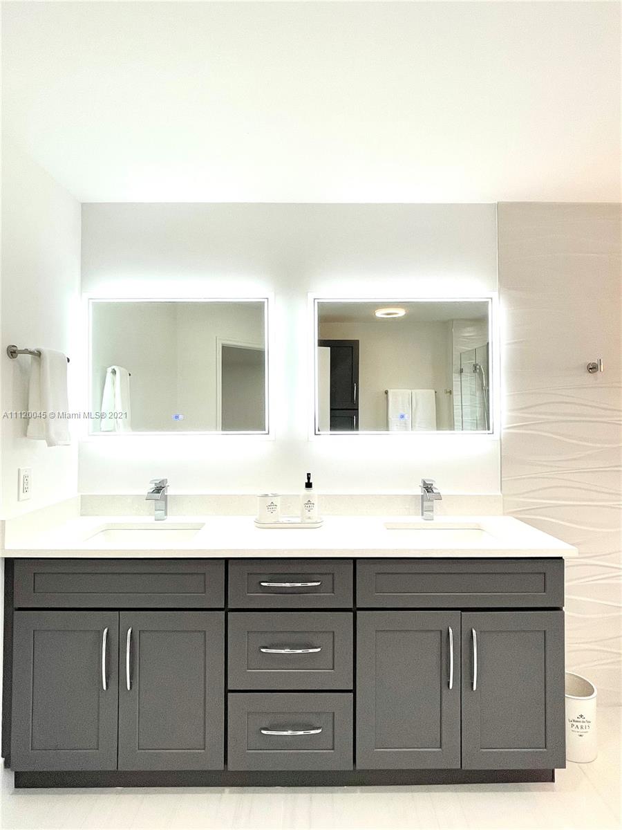 6726 Via Regina Boca Raton, FL 33433 - Photo 25 of 35 a bathroom with a double vanity sink and mirror