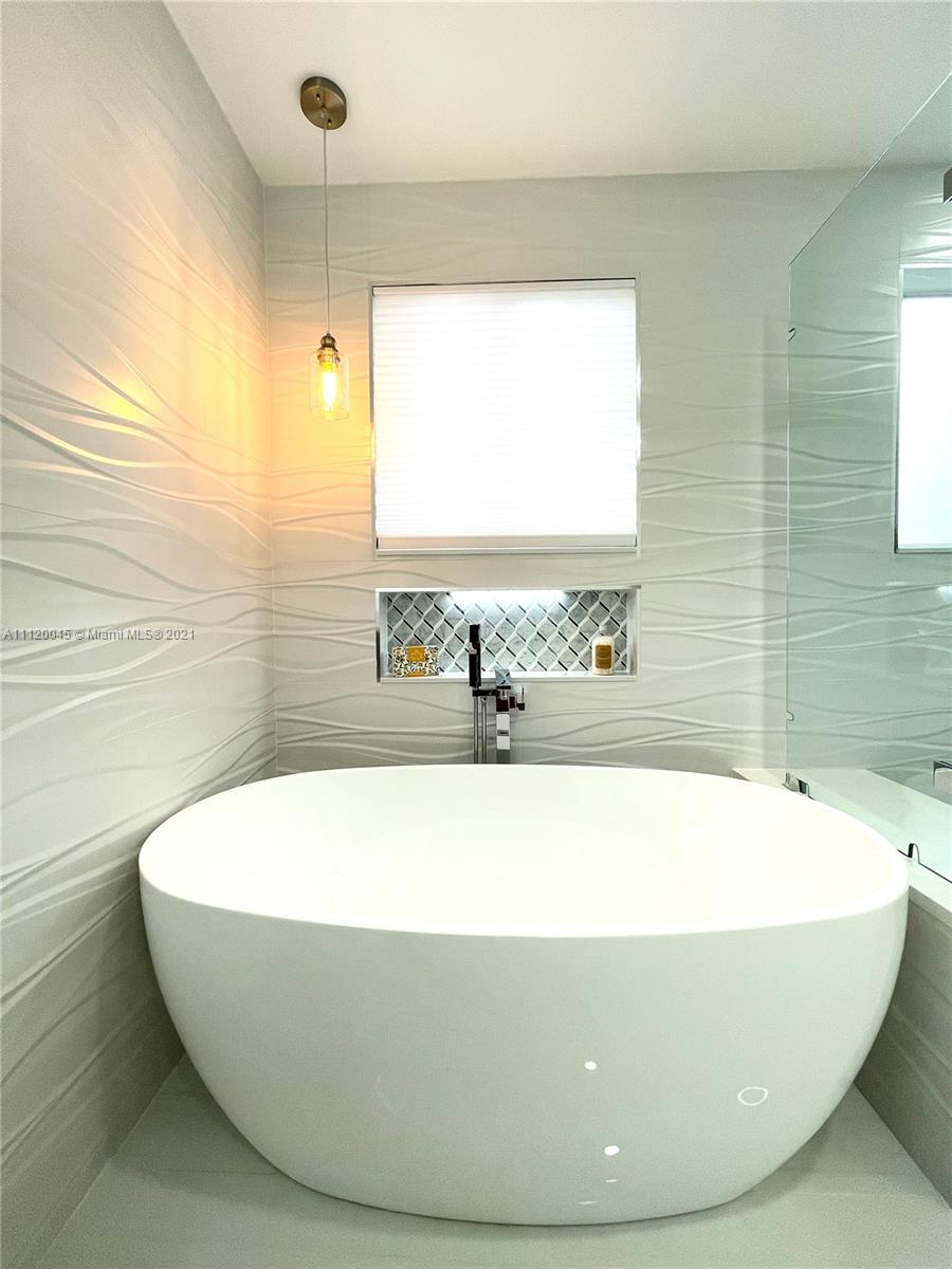 6726 Via Regina Boca Raton, FL 33433 - Photo 26 of 35 a white bath tub sitting in a bathroom