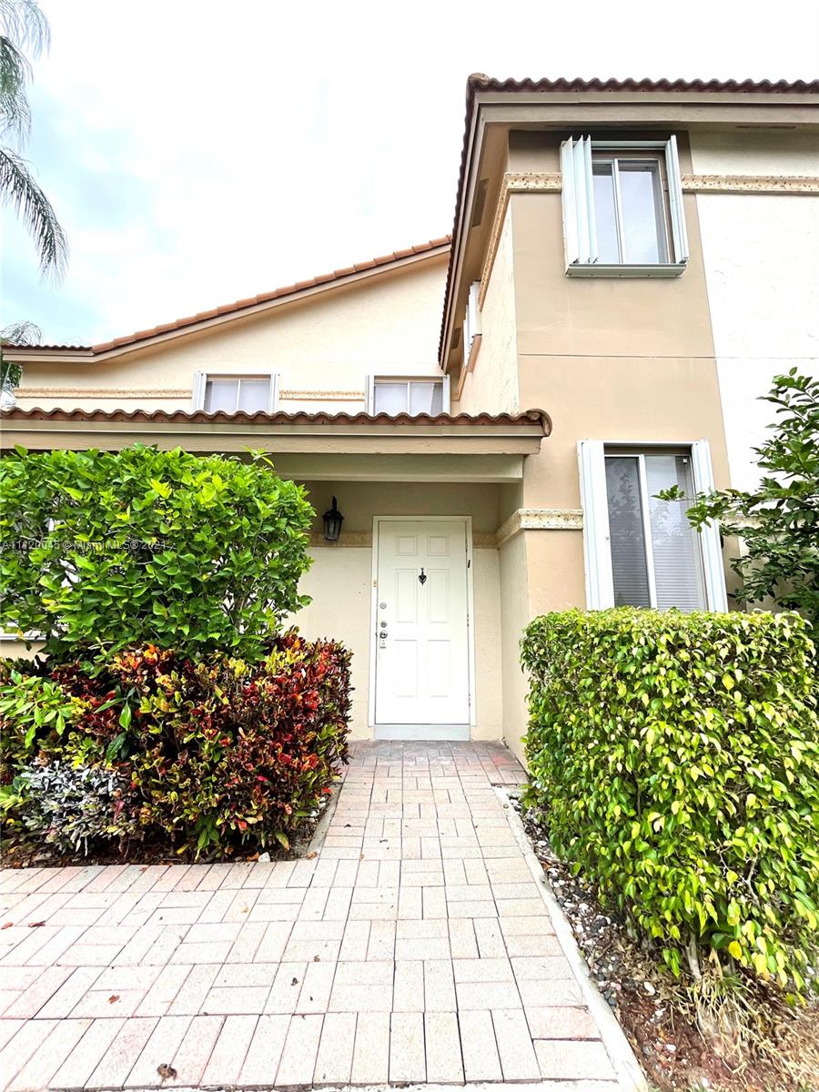 6726 Via Regina Boca Raton, FL 33433 - Photo 29 of 35 a front view of a house with a garden