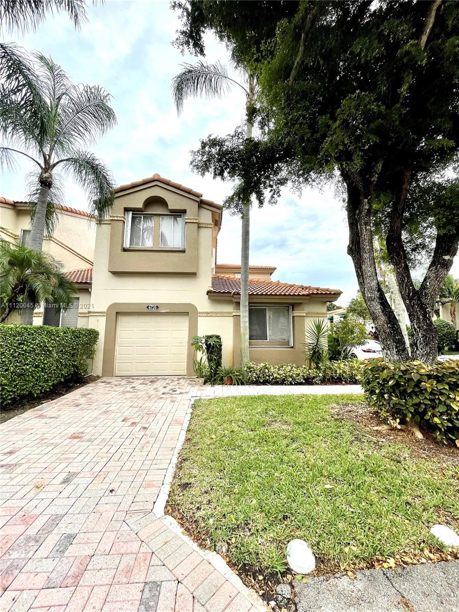 6726 Via Regina Boca Raton, FL 33433 - Photo 30 of 35 a front view of a house with a yard and garage