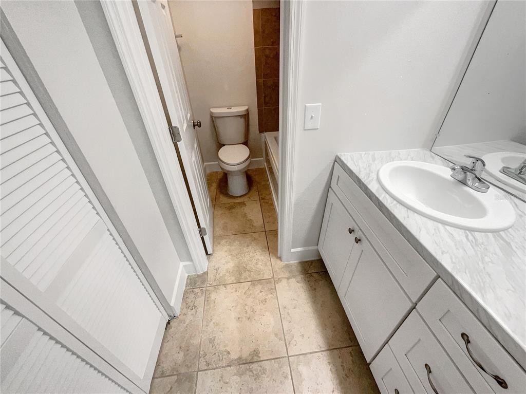 1028 Apollo Beach Boulevard, Unit 103 Apollo Beach, FL 33572 - Photo 16 of 22 a bathroom with a sink a toilet and a mirror