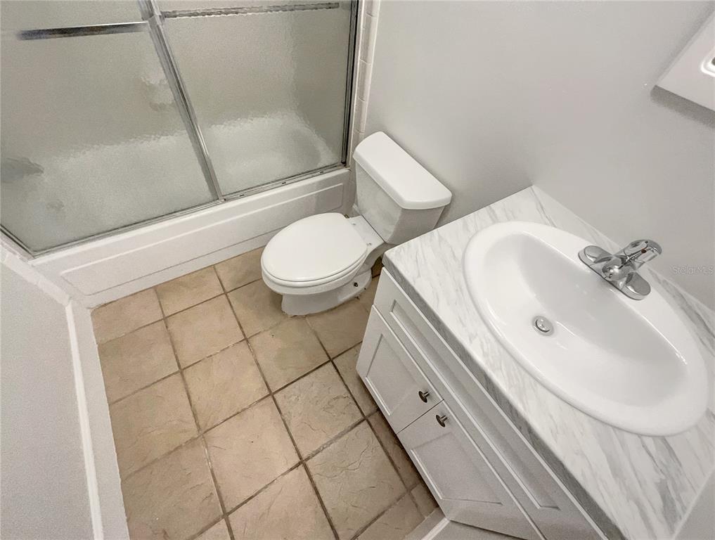 1028 Apollo Beach Boulevard, Unit 103 Apollo Beach, FL 33572 - Photo 17 of 22 a bathroom with a sink a toilet and shower