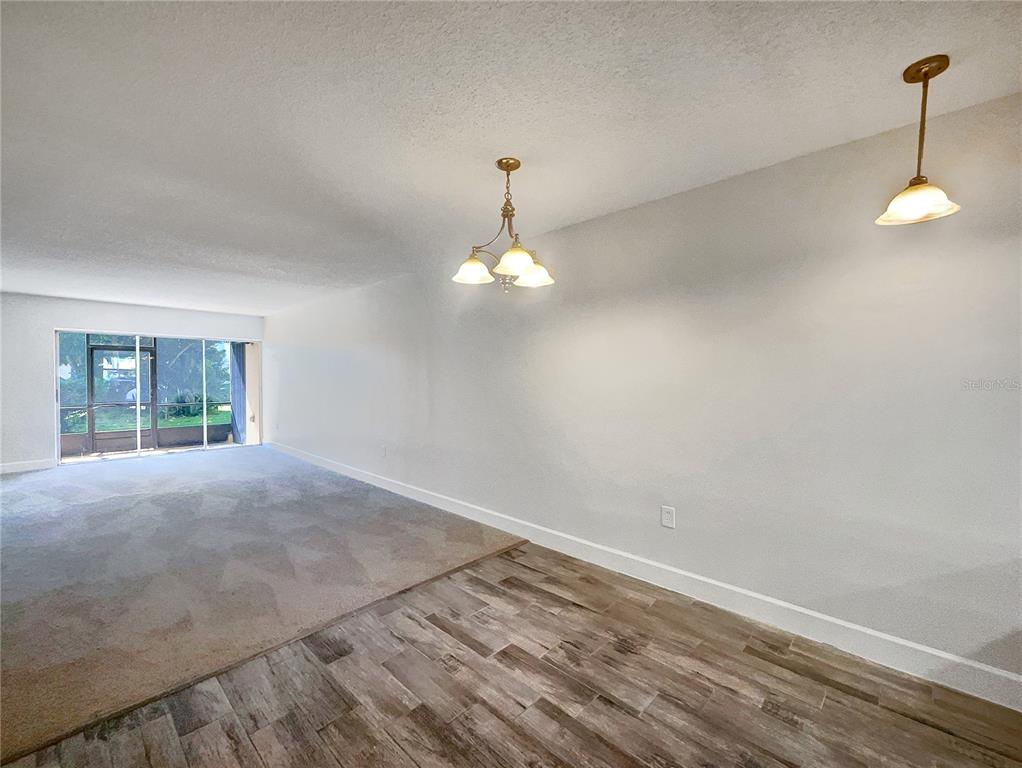 1028 Apollo Beach Boulevard, Unit 103 Apollo Beach, FL 33572 - Photo 3 of 22 a view of empty room with wooden floor and fan