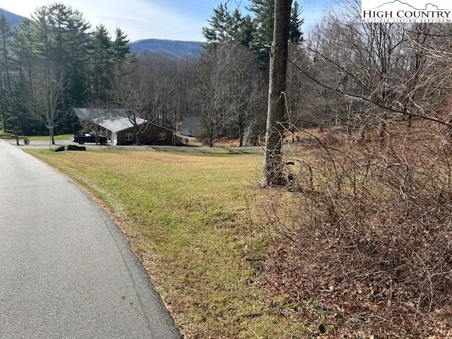 a view of a house with a yard covered with snow