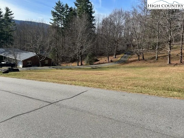 a view of a field with trees in front of it