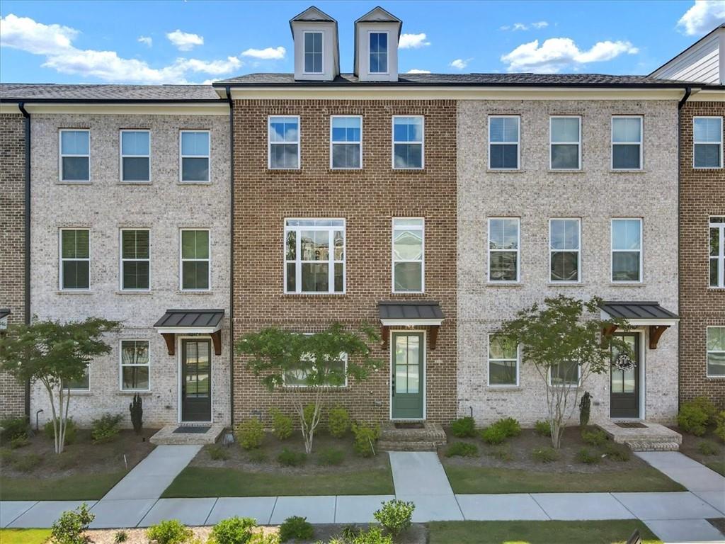 a front view of a house with yard