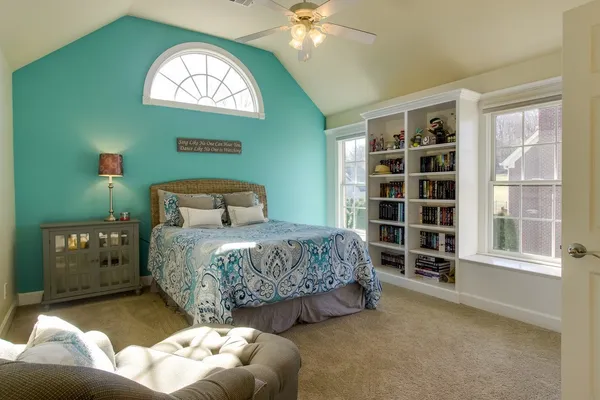 a bedroom with a bed and a window