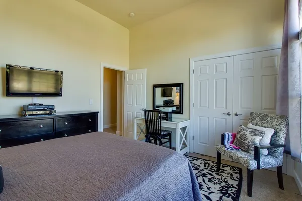a bedroom with a bed and a flat screen tv