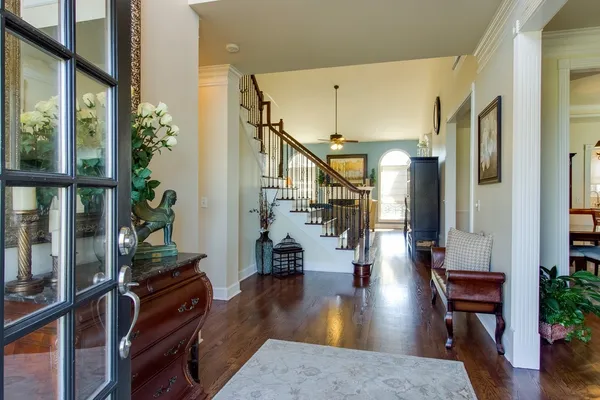 a living room with furniture and wooden floor