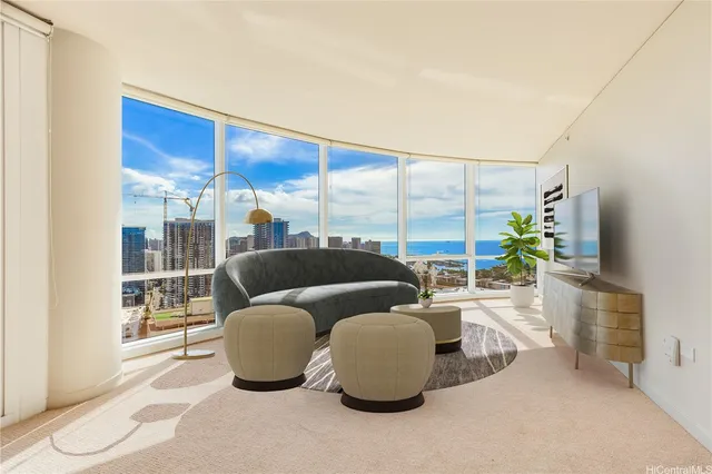 a living room with furniture and a floor to ceiling window