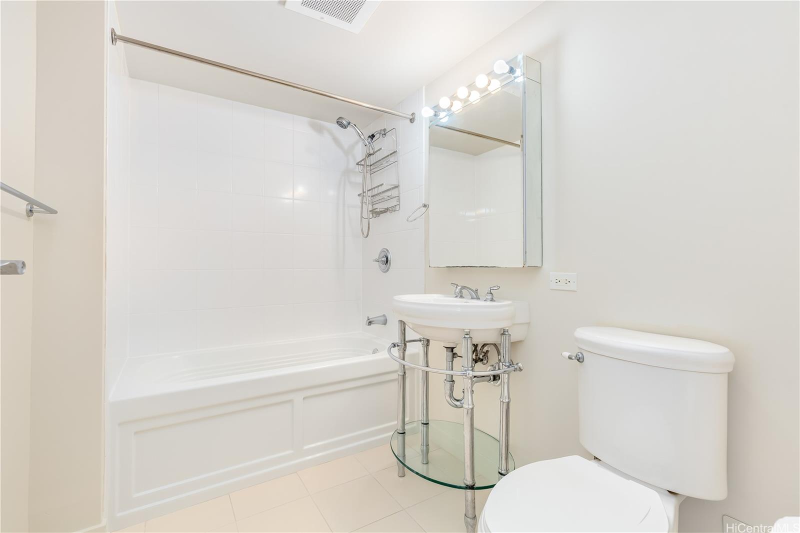 1288 Kapiolani Boulevard, Unit I4203 Honolulu, HI 96814 - Photo 11 of 25 a bathroom with a sink toilet and shower