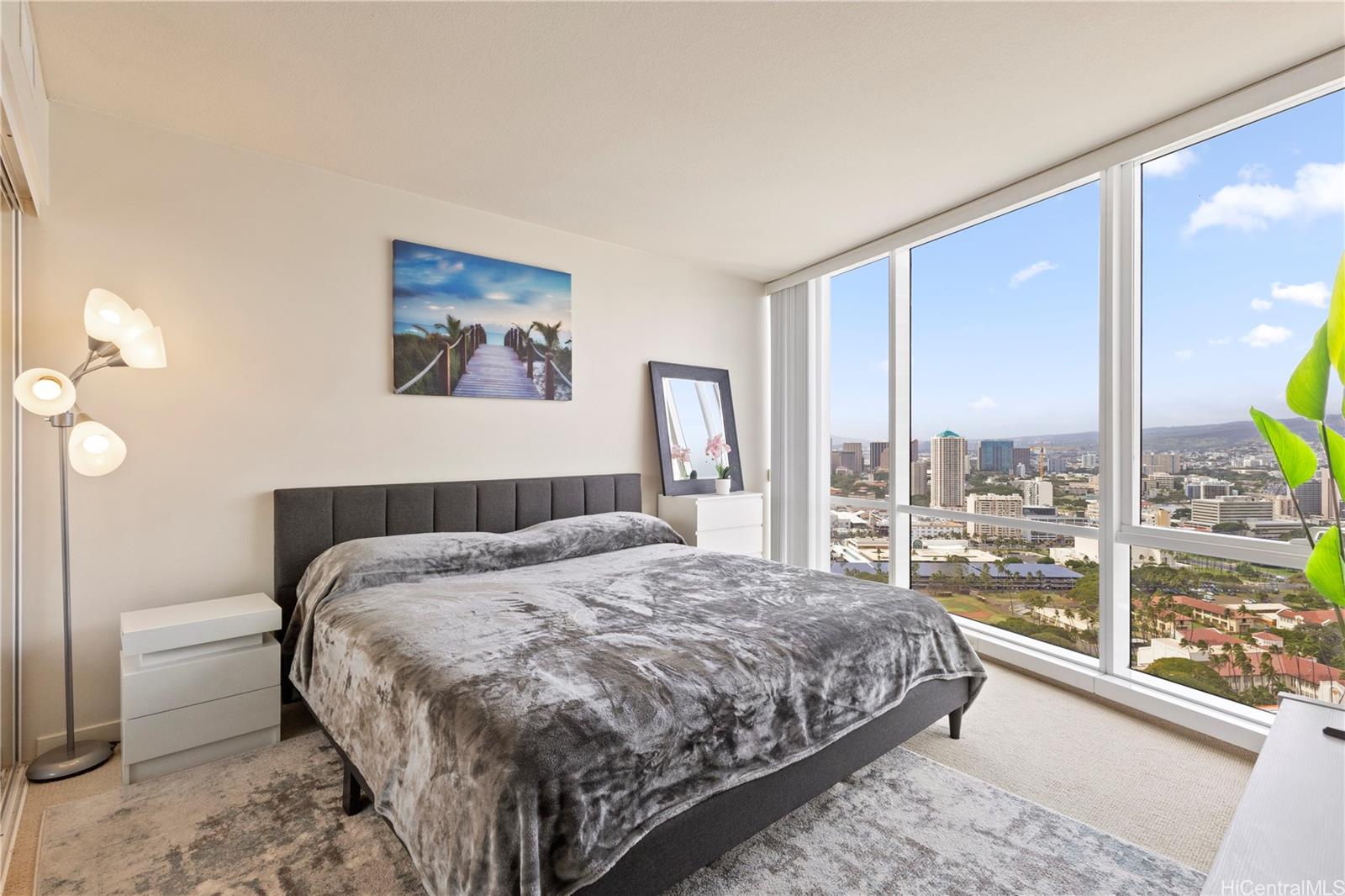 1288 Kapiolani Boulevard, Unit I4203 Honolulu, HI 96814 - Photo 15 of 25 a bedroom with a large bed and a large window