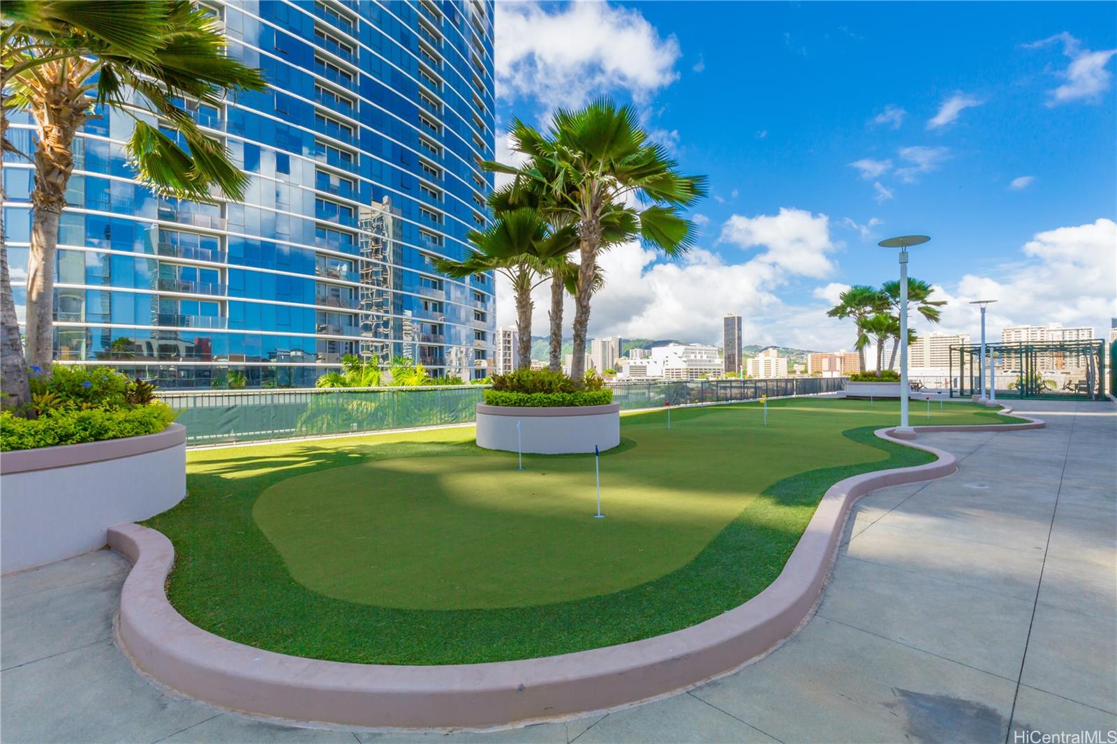 1288 Kapiolani Boulevard, Unit I4203 Honolulu, HI 96814 - Photo 20 of 25 a view of a swimming pool with a yard