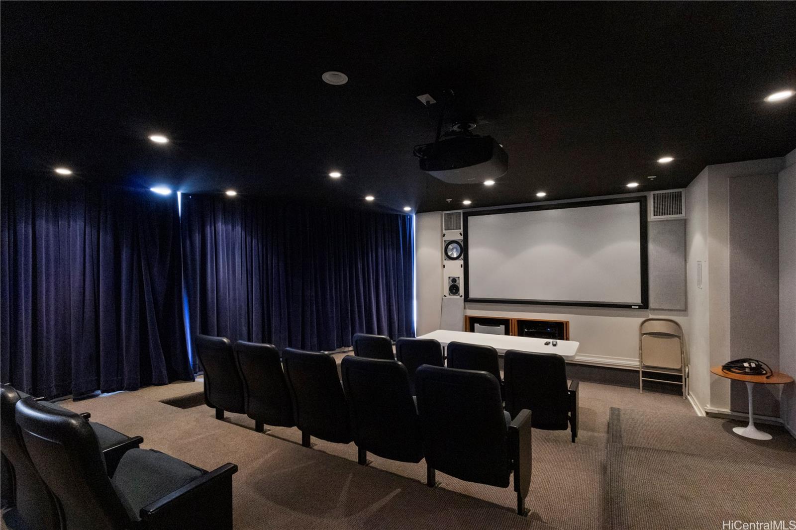 1288 Kapiolani Boulevard, Unit I4203 Honolulu, HI 96814 - Photo 23 of 25 a media room with lots of chairs and a projector screen