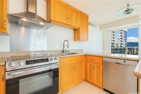 a kitchen with stainless steel appliances granite countertop a sink and cabinets