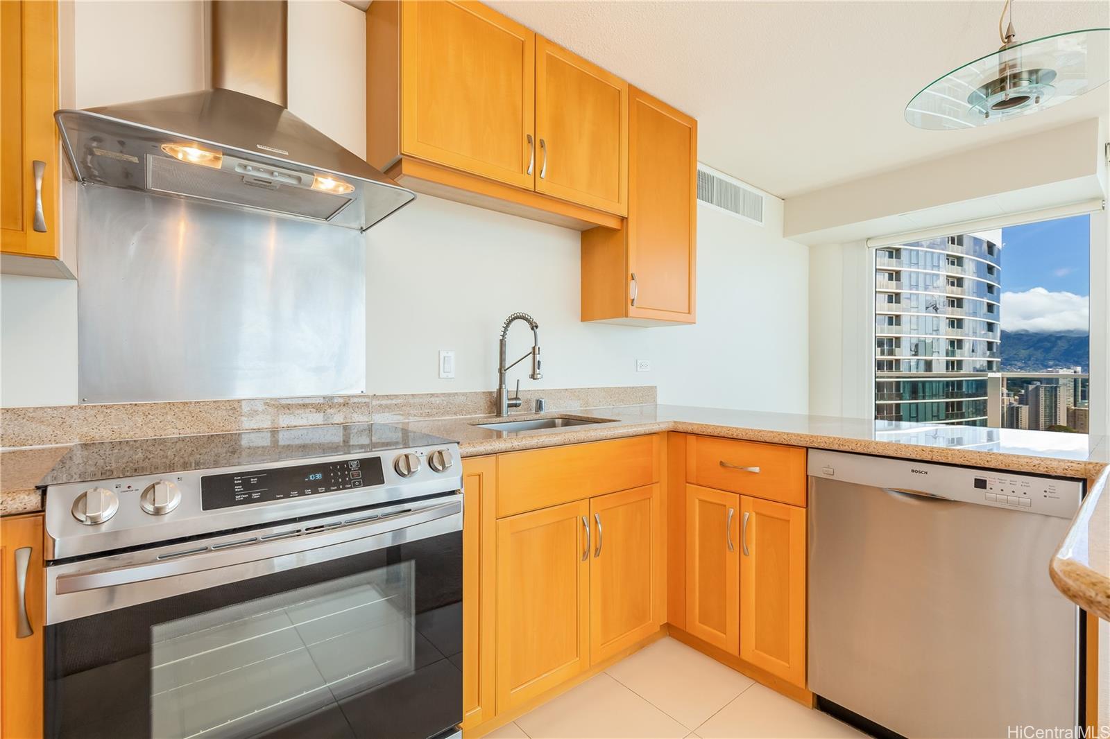 1288 Kapiolani Boulevard, Unit I4203 Honolulu, HI 96814 - Photo 5 of 25 a kitchen with stainless steel appliances granite countertop a sink and cabinets