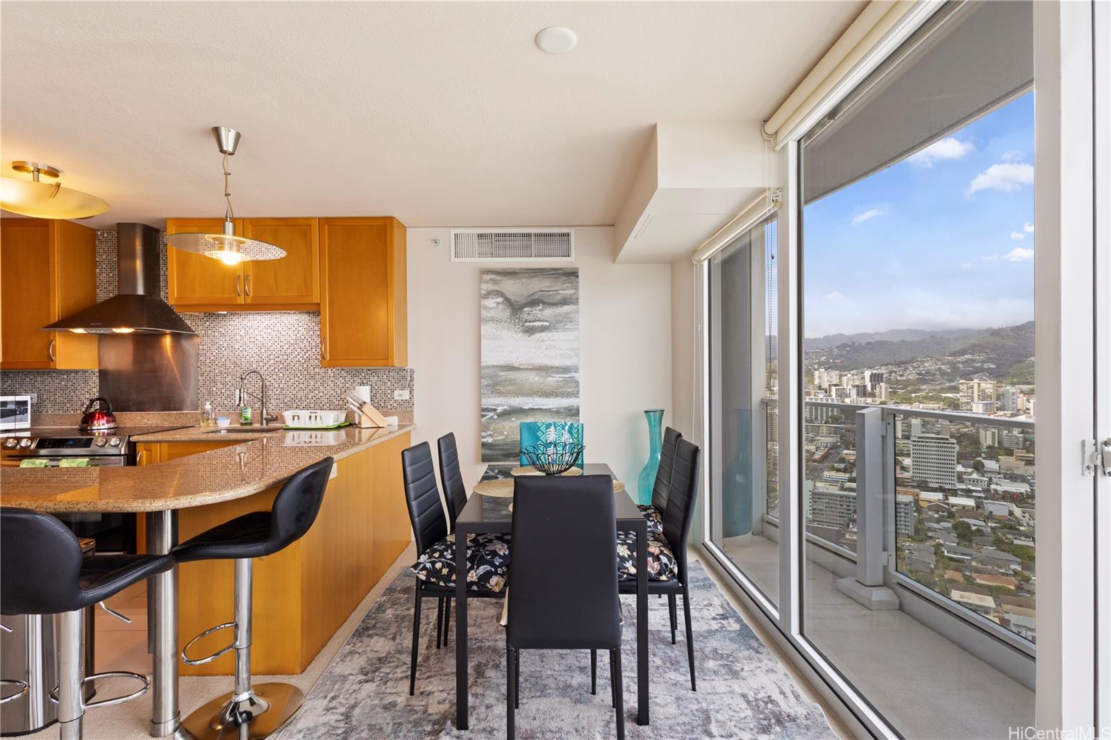 1288 Kapiolani Boulevard, Unit I4203 Honolulu, HI 96814 - Photo 6 of 25 a dining room with furniture a chandelier and wooden floor